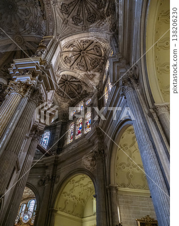 Malaga Cathedral Interior With Ornate Stained Glass, Columns and Elaborate Sculpted Ceiling in Dramatic Perspective Malaga Cathedral Interior With Ornate Stained Glass, Columns and Elaborate Sculpted Ceiling in Dramatic Perspective 138206230