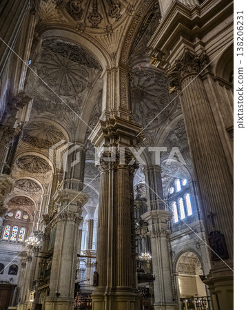 Malaga Cathedral Interior With Ornate Stained Glass, Columns and Elaborate Sculpted Ceiling in Dramatic Perspective Malaga Cathedral Interior With Ornate Stained Glass, Columns and Elaborate Sculpted Ceiling in Dramatic Perspective 138206231