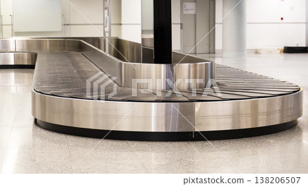 Empty airport baggage carousel with number sign in modern terminal interior waiting arriving luggage. 138206507