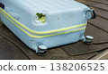 Damaged hard shell suitcase with hole and visible interior on baggage conveyor belt airport close up view. 138206525