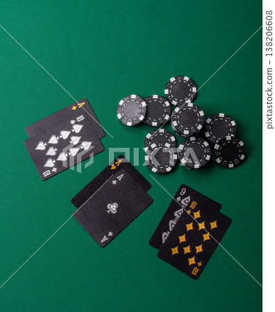 Playing cards and chips on a green cloth, a gambling game of blackjack or baccarat. Cards and chips Playing cards and chips on a green cloth, a gambling game of blackjack or baccarat. Cards and chips 138206608