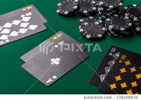 Playing cards and chips on a green cloth, a gambling game of blackjack or baccarat. Cards and chips Playing cards and chips on a green cloth, a gambling game of blackjack or baccarat. Cards and chips 138206610