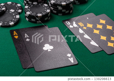 Playing cards and chips on a green cloth, a gambling game of blackjack or baccarat. Cards and chips Playing cards and chips on a green cloth, a gambling game of blackjack or baccarat. Cards and chips 138206613