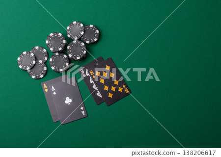 Playing cards and chips on a green cloth, a gambling game of blackjack or baccarat. Cards and chips 138206617