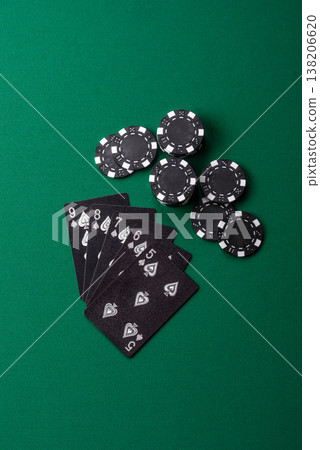 Playing cards and chips on a green cloth, a gambling game of poker. Cards and chips Playing cards and chips on a green cloth, a gambling game of poker. Cards and chips 138206620
