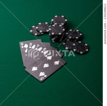 Playing cards and chips on a green cloth, a gambling game of poker. Cards and chips Playing cards and chips on a green cloth, a gambling game of poker. Cards and chips 138206621