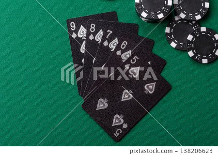 Playing cards and chips on a green cloth, a gambling game of poker. Cards and chips 138206623