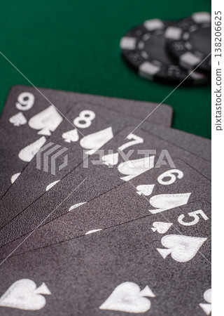 Playing cards and chips on a green cloth, a gambling game of poker. Cards and chips Playing cards and chips on a green cloth, a gambling game of poker. Cards and chips 138206625