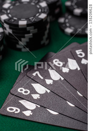 Playing cards and chips on a green cloth, a gambling game of poker. Cards and chips 138206628