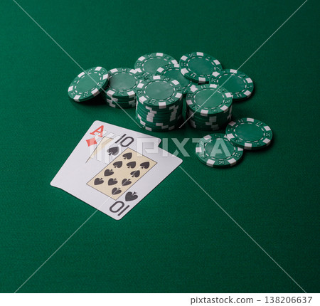 Playing cards and chips on a green cloth, a gambling game of blackjack or baccarat. Cards and chips Playing cards and chips on a green cloth, a gambling game of blackjack or baccarat. Cards and chips 138206637