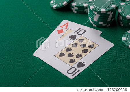 Playing cards and chips on a green cloth, a gambling game of blackjack or baccarat. Cards and chips Playing cards and chips on a green cloth, a gambling game of blackjack or baccarat. Cards and chips 138206638