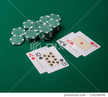 Playing cards and chips on a green cloth, a gambling game of blackjack or baccarat. Cards and chips Playing cards and chips on a green cloth, a gambling game of blackjack or baccarat. Cards and chips 138206646