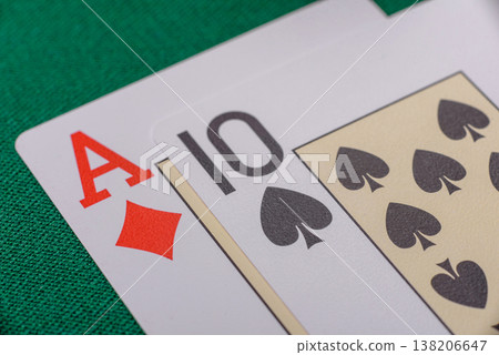 Playing cards and chips on a green cloth, a gambling game of blackjack or baccarat. Cards and chips Playing cards and chips on a green cloth, a gambling game of blackjack or baccarat. Cards and chips 138206647