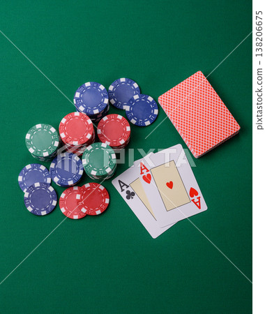 Playing cards and chips on a green cloth, a gambling game of blackjack or baccarat. Cards and chips Playing cards and chips on a green cloth, a gambling game of blackjack or baccarat. Cards and chips 138206675