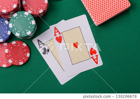 Playing cards and chips on a green cloth, a gambling game of blackjack or baccarat. Cards and chips Playing cards and chips on a green cloth, a gambling game of blackjack or baccarat. Cards and chips 138206678