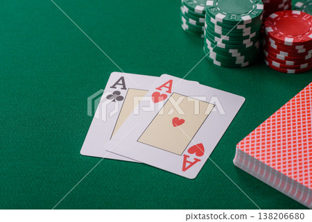 Playing cards and chips on a green cloth, a gambling game of blackjack or baccarat. Cards and chips Playing cards and chips on a green cloth, a gambling game of blackjack or baccarat. Cards and chips 138206680