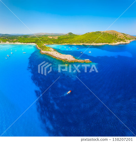 Aerial view of Cala Agulla beach and turquoise bay with boats in Mallorca. Aerial view of Cala Agulla beach and turquoise bay with boats in Mallorca. 138207201
