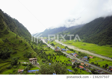 A view overlooking a mountain village and valley in Nepal. A view overlooking a mountain village and valley in Nepal. 138207507