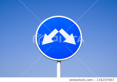 The sign of the crossing. Road signs. Sign on a blue background The sign of the crossing. Road signs. Sign on a blue background 138207667