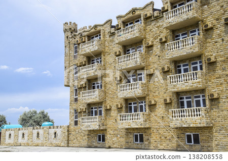 The hotel building, covered with decorative stone. Multi-storey hotel with a decorative trim, which is called Dagestani stone 138208558