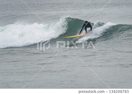 Surfer in action on the ocean waves Surfer in action on the ocean waves 138208783