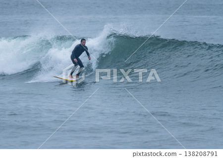 Surfer in action on the ocean waves Surfer in action on the ocean waves 138208791