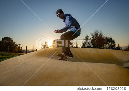 Skateboarder on a pump track park 138208918