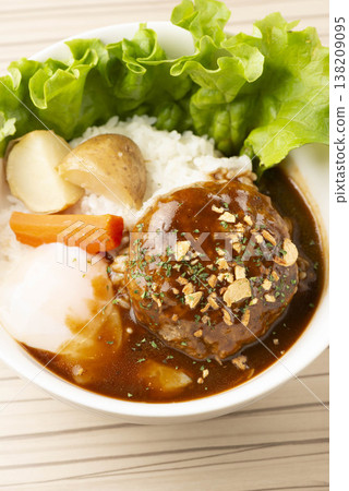 A simple hamburger steak served on a white plate. A homemade-style meat dish on the table. A classic Western dish. 138209095