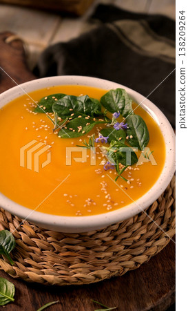 Creamy Pumpkin Soup with Spinach Rosemary and Sesame Seeds 138209264
