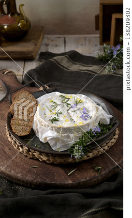 Baked Camembert Cheese with Rosemary and Toasted Bread on Rustic Wooden Board Baked Camembert Cheese with Rosemary and Toasted Bread on Rustic Wooden Board 138209302