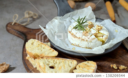 Baked Camembert Cheese with Honey Walnuts and Toasted Baguette 138209344