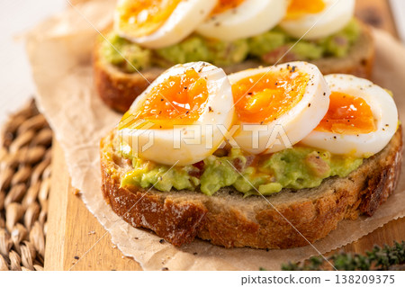 Sourdough Toast with Smashed Avocado and Soft Boiled Egg Slices Sourdough Toast with Smashed Avocado and Soft Boiled Egg Slices 138209375