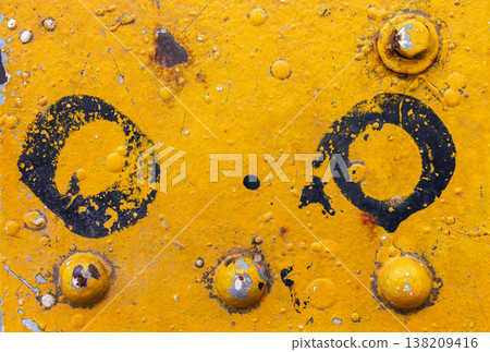 Yellow painted metal surface with rivets, rust, dirt, and black circle paint marks. industrial grunge texture background Yellow painted metal surface with rivets, rust, dirt, and black circle paint marks. industrial grunge texture background 138209416