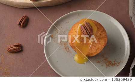Maple Pecan Muffin with Caramel Glaze on a Modern Grey Plate 138209429