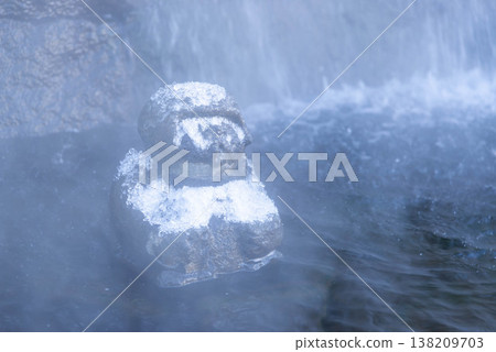 A scene of a stone statue enveloped in steam in the snow-covered Jozankei Onsen hot spring resort in Hokkaido. A scene of a stone statue enveloped in steam in the snow-covered Jozankei Onsen hot spring resort in Hokkaido. 138209703