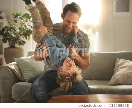 Cheerful Father Playing Upside Down With His Young Son Cheerful Father Playing Upside Down With His Young Son 138209868