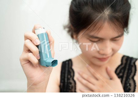 Asthma and chronic obstructive pulmonary disease COPD, Asian teenage using metered dose inhaler MDI. 138210326