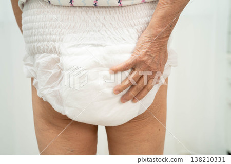 Asian senior woman patient wearing adult incontinence diaper pad in hospital. Asian senior woman patient wearing adult incontinence diaper pad in hospital. 138210331