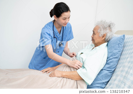 Asian doctor checking and treat elderly woman patient health in hospital. Asian doctor checking and treat elderly woman patient health in hospital. 138210347