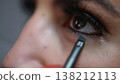 Beauty Trends and Self-Care Rituals Close-up of Woman Applying Eyeliner with brush for Makeup 138212113