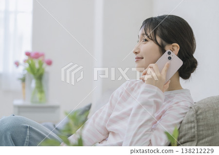 A young woman talking on a smartphone A young woman talking on a smartphone 138212229
