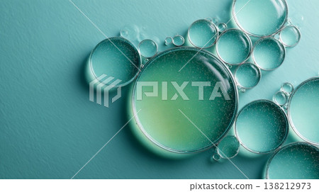 Droplets of oil and water creating a textured abstract background, showcasing science, chemistry, and liquid dynamics with vibrant green and blue tones 138212973