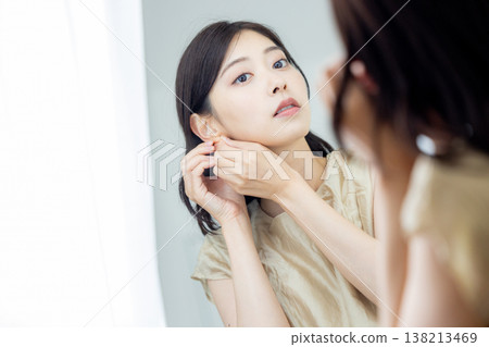 A woman getting ready in the mirror 138213469