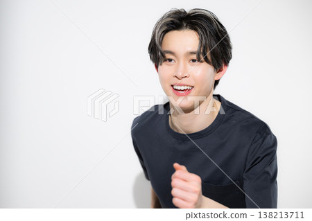 An image of a refreshing young man in a running pose, looking up at his running goal. An image of a refreshing young man in a running pose, looking up at his running goal. 138213711