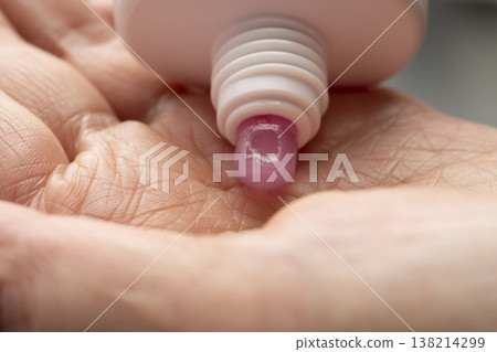 A woman's hands applying makeup; hands applying makeup; facial cleanser. A woman's hands applying makeup; hands applying makeup; facial cleanser. 138214299