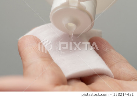 A woman's hands applying makeup; hands applying lotion. A woman's hands applying makeup; hands applying lotion. 138214451
