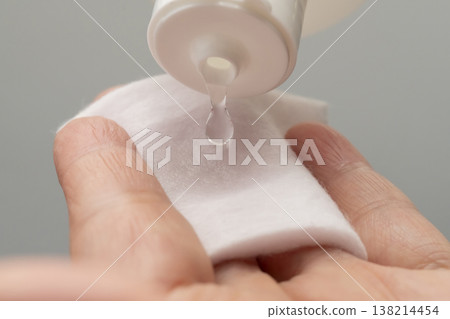 A woman's hands applying makeup; hands applying lotion. A woman's hands applying makeup; hands applying lotion. 138214454