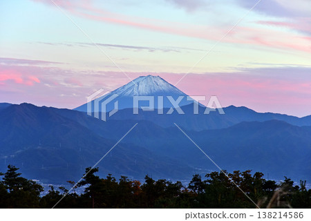 At dusk, Mount Fuji can be seen across the Kofu Basin. 138214586