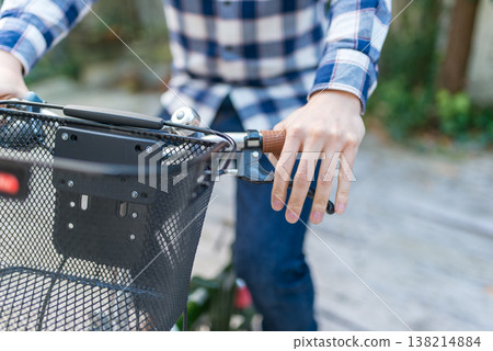 Hands of a man riding a bicycle 138214884