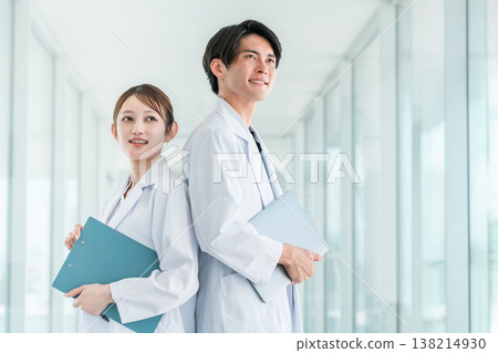 Male and female researchers, scientists, and research staff in white coats (pharmaceutical company, research institute) 138214930